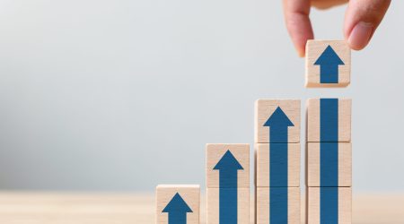 Ladder career path for business growth success process concept.Hand arranging wood block stacking as step stair with arrow up